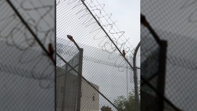 prison escape sandals on fence