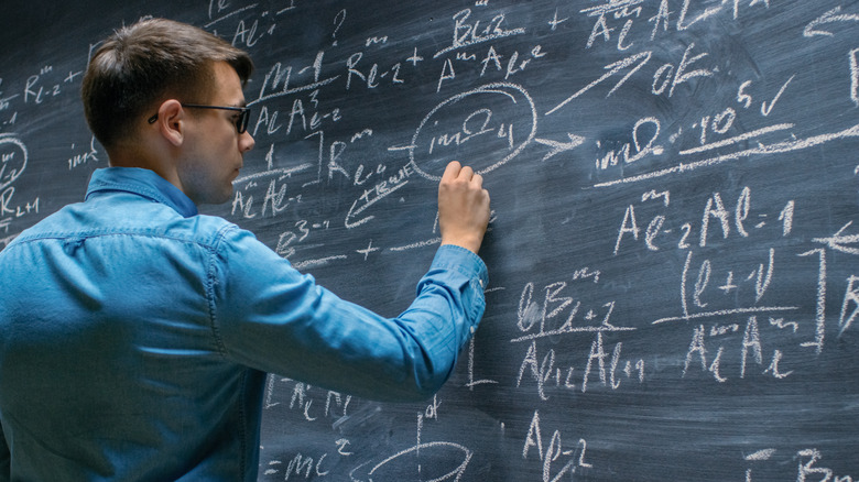 Scientist working on chalkboard