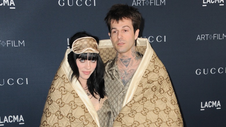 Billie Eilish and Jesse Rutherford wrapped in blanket