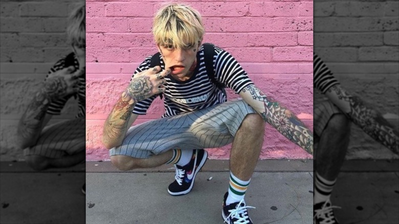 Lil Peep in front of a brick wall 