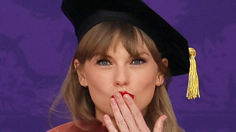 Taylor Swift sending a kiss during graduation