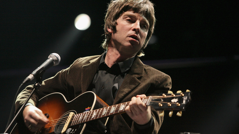 Noel Gallagher plays guitar