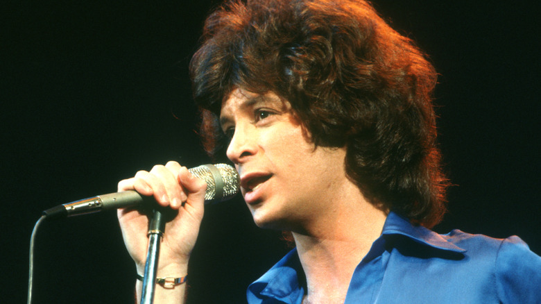 Eric Carmen singing into a microphone