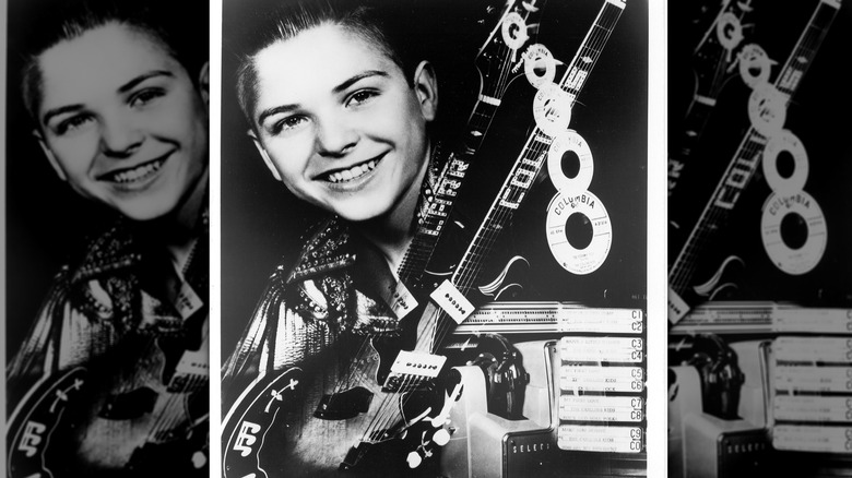 Larry Collins as kid holding double-necked guitar