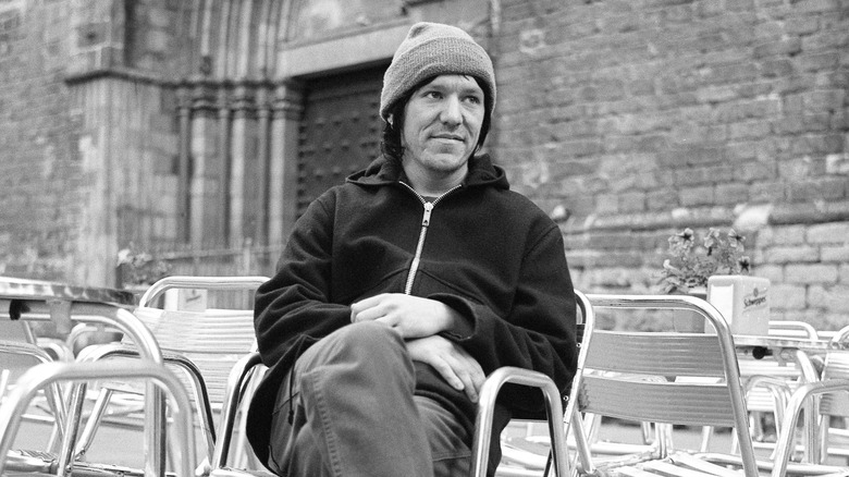 Elliott Smith, seated and looking away