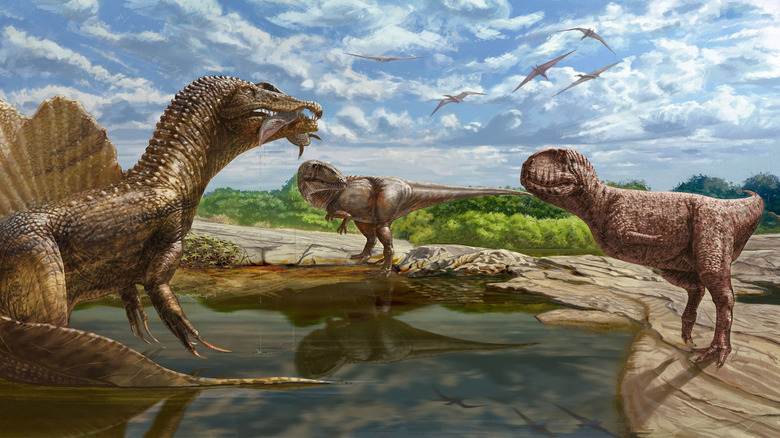 dinosaurs gather near water