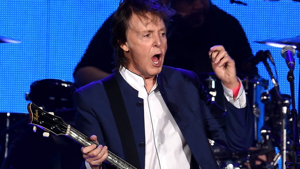 McCartney singing on stage blue suit