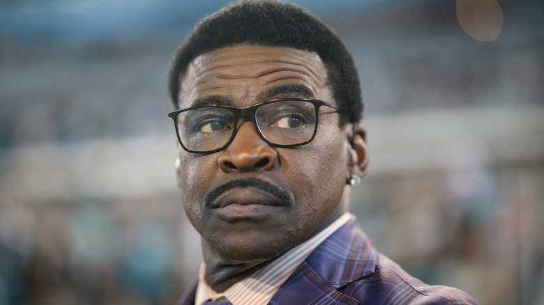 Michael Irvin watching football game glasses suit
