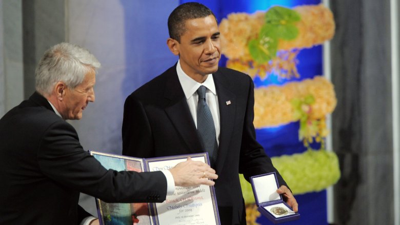 Barack Obama holding medal