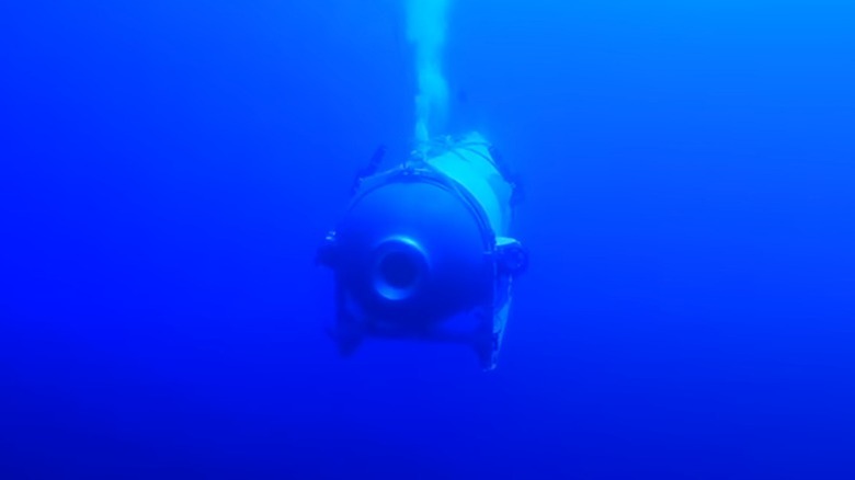 The Titan submersible expelling bubbles in deep blue water