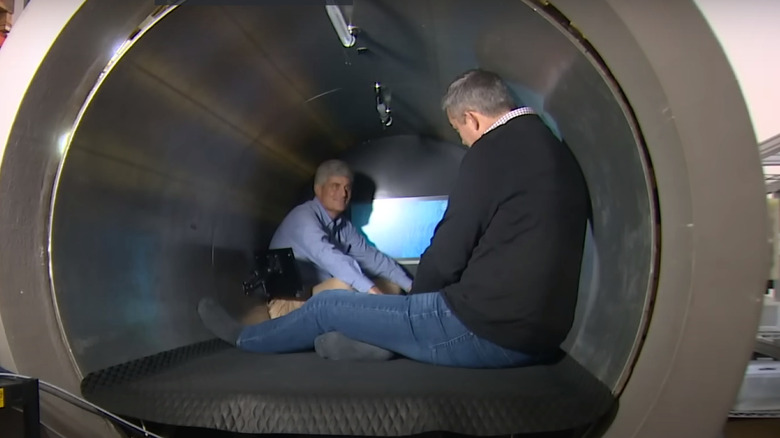 Stockton Rush and a reporter sit inside a carbon hulled submersible