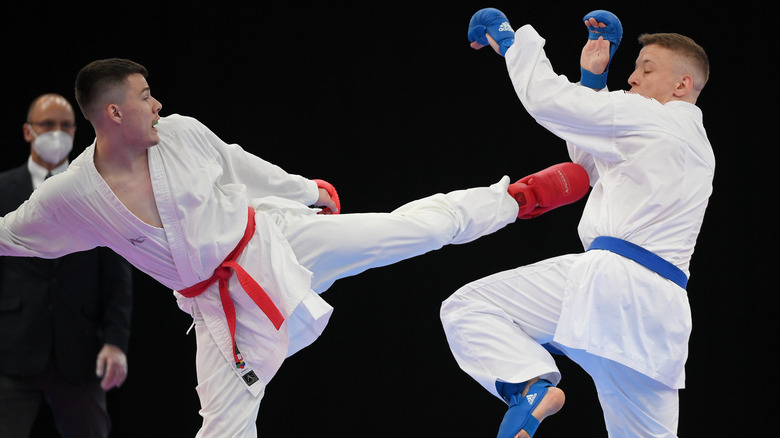 Marcel Shepelev (red) fights Maximilian Spisal (blue) in karate competition