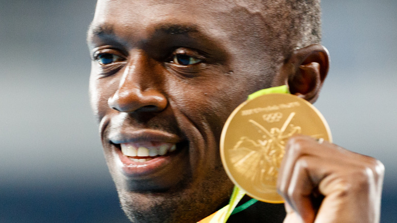 Usain Bolt with gold Olympic medal