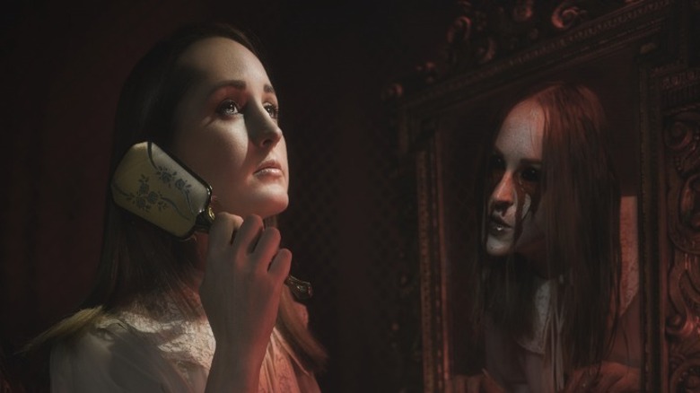Young woman combing her hair in front of a mirror with a ghostly version of herself peering out