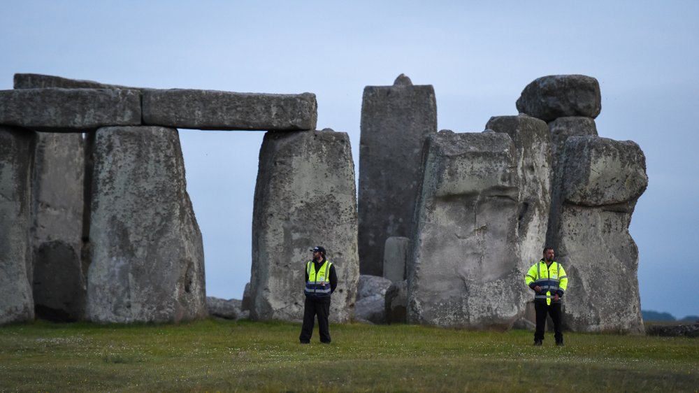 People standing before Stonehenge