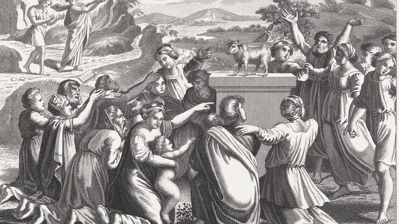Israelites worshiping golden calf as Moses approaches