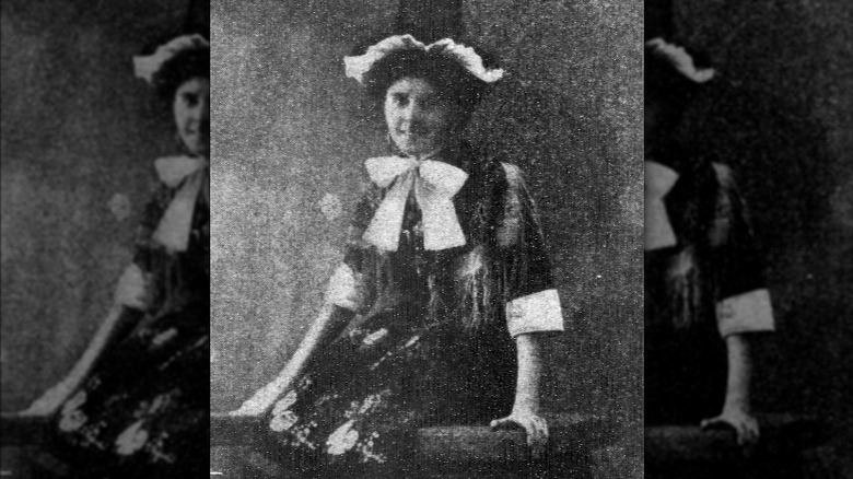 Violet Charlesworth in a costume with a large bow