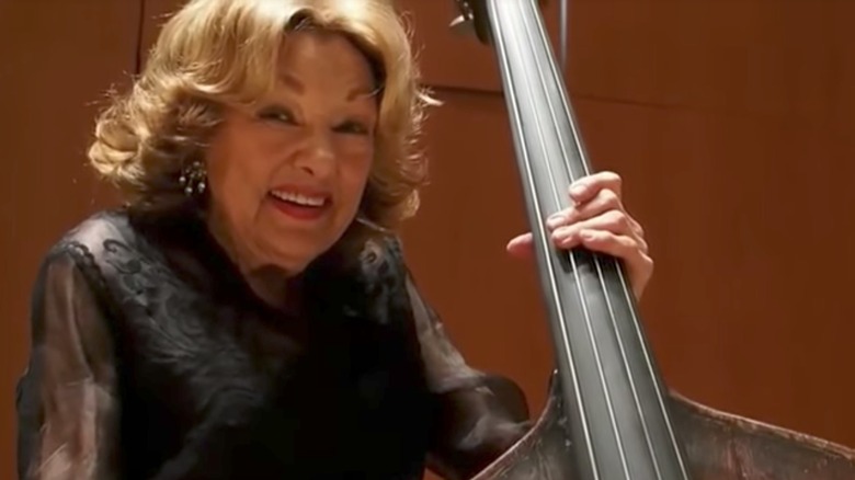 Jane Little smiling holding double-bass