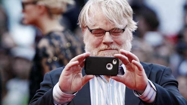 Philip Seymour Hoffman taking a photo with camera