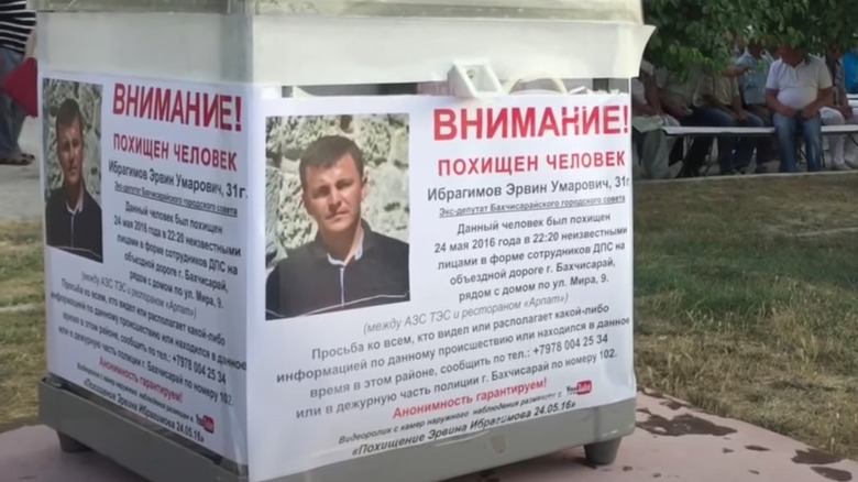 Ervin Ibragimov's search poster on a donation box