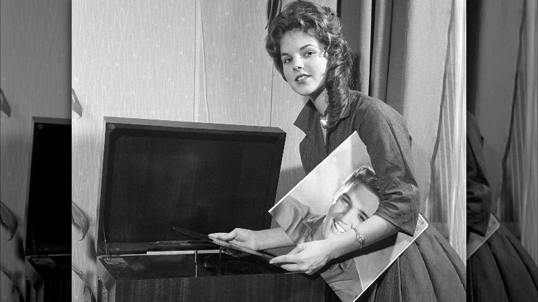 Priscilla Presley playing Elvis' record