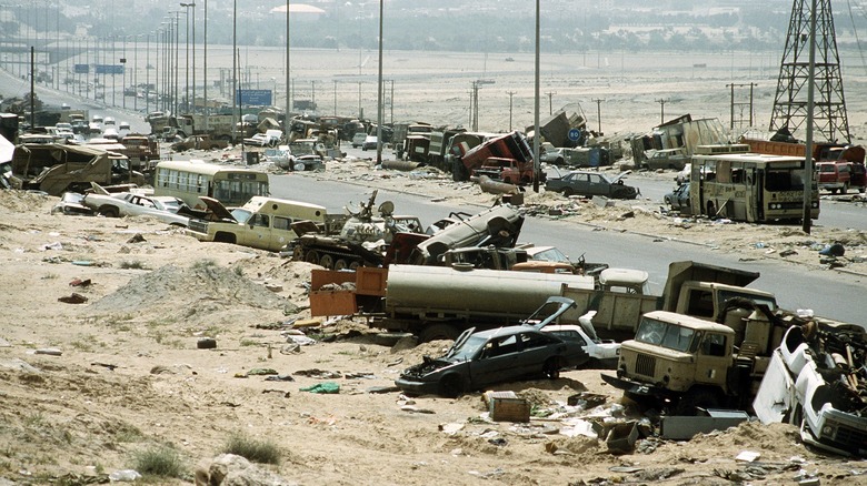 abandoned debris vehicles line desert highway