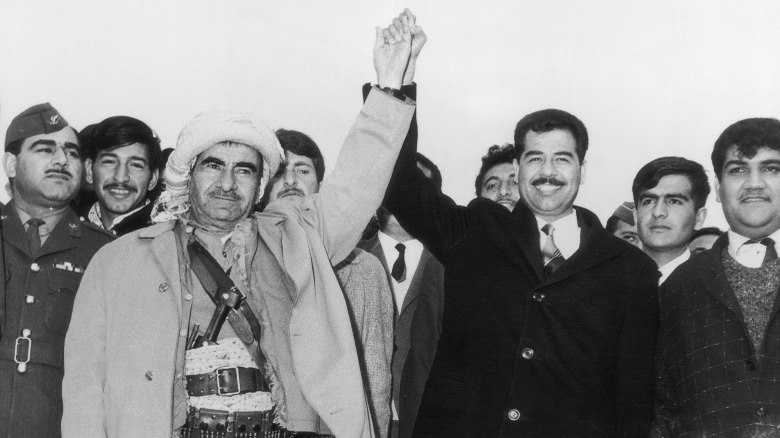 Mustapha Barzani and Saddam Hussein shaking hands