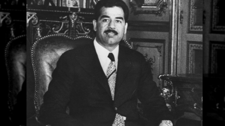 Saddam Hussein sitting in chair