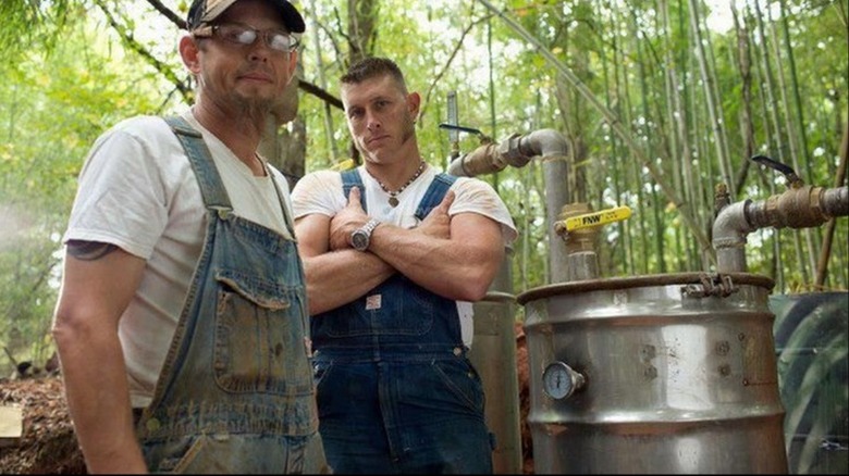 Two men woods cooking moonshine