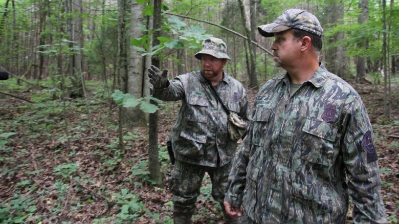 two men camouflage woods