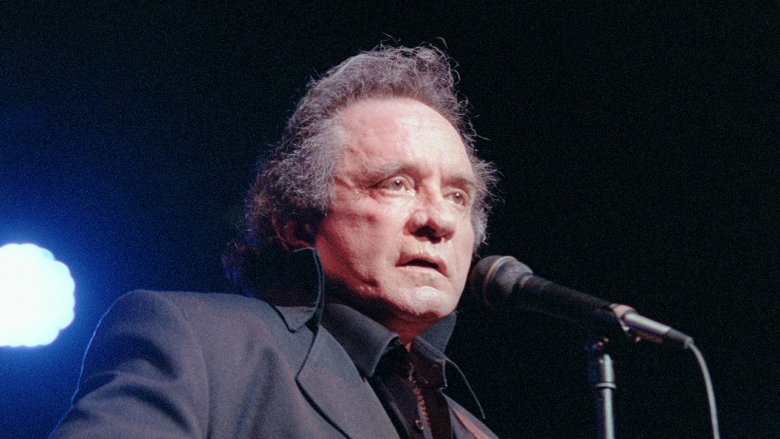 Johnny Cash on stage dark suit mic