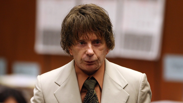 Phil Spector in brown wig and white suit