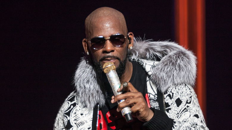 R. Kelly onstage with microphone and cigar