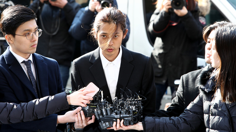 Jung Joon-young in suit giving statement