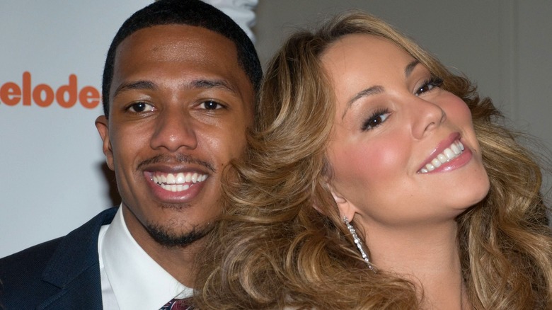 Mariah Carey and Nick Cannon smiling at event