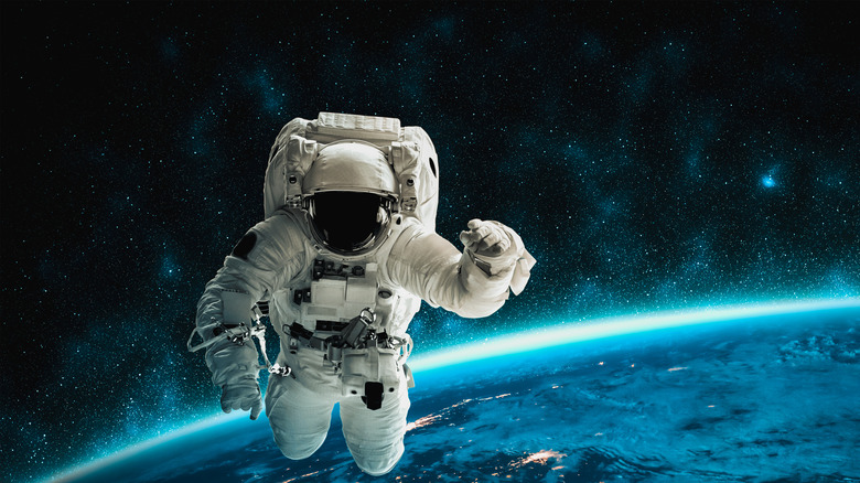 Astronaut floating in space with Earth's curve in background