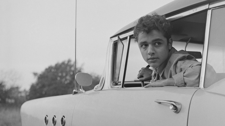 Sal Mineo leaning out a car window