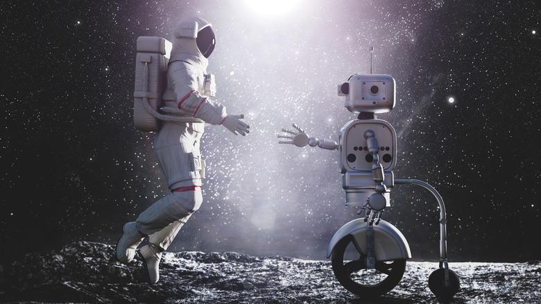Astronaut shaking hands with robot