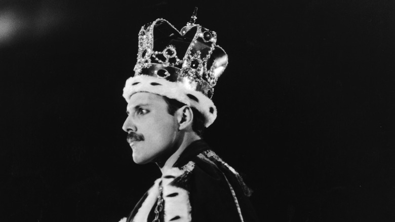 Freddie Mercury on stage with a crown on his head