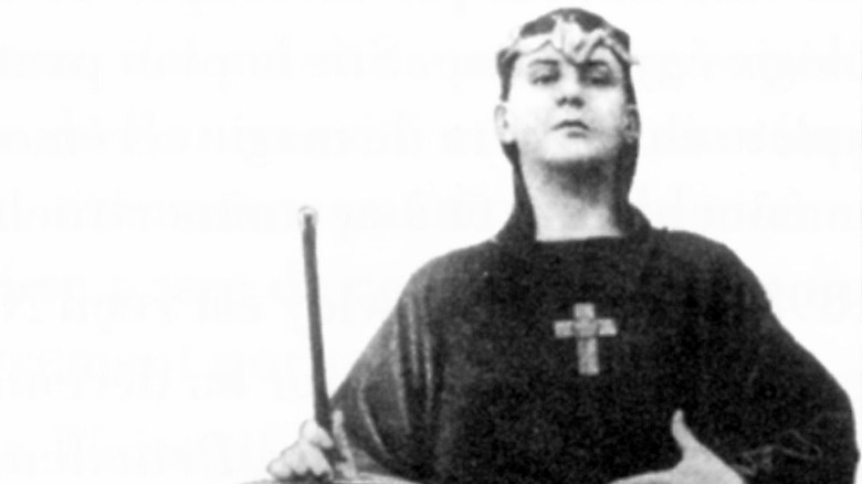 Aleister Crowley wearing robe and cross