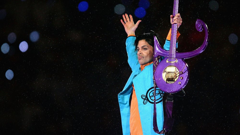 Prince holding guitar