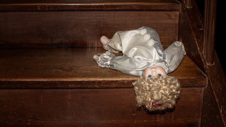 doll dropped on a staircase