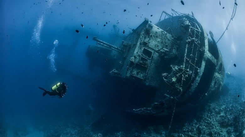wreck of a ship with a scuba diver