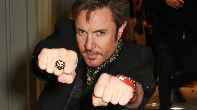 Simon Le Bon holding his fists out in 2015