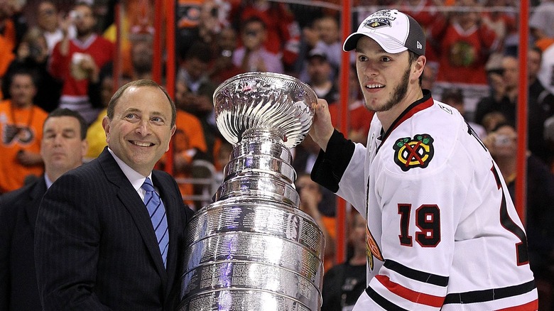 Gary Bettman and Jonathan Toews hold Stanley Cup