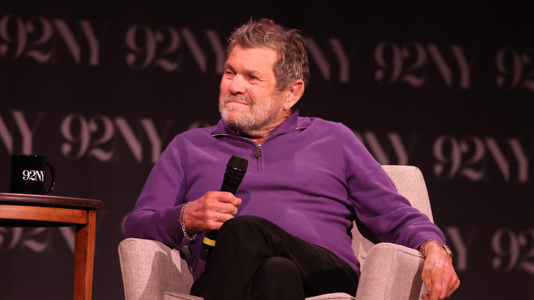 Jann Wenner seated with microphone
