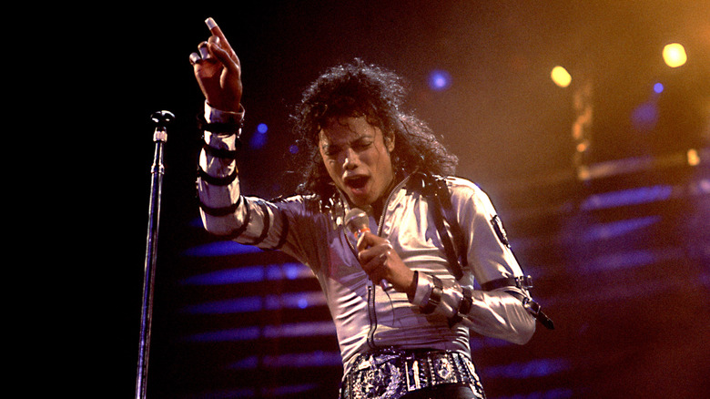 Michael Jackson arm raised mic singing on stage