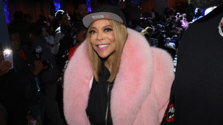 Wendy Williams in black ballcap and pink jacket