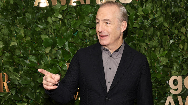 Bob Odenkirk gesturing to press at an event