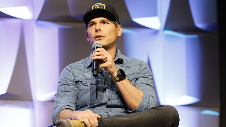 Granger Smith in baseball cap with microphone